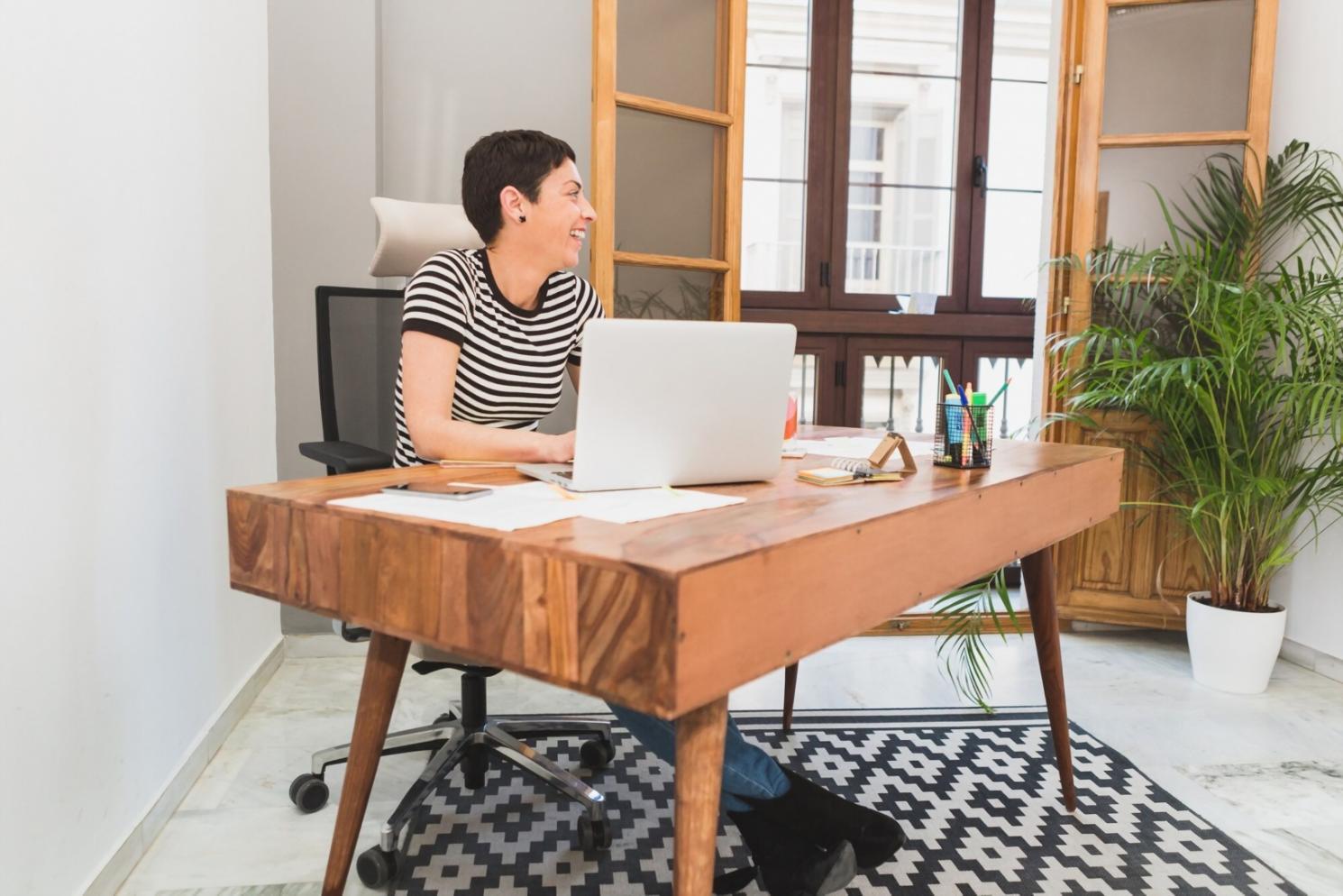 Person organizing financial documents at home desk